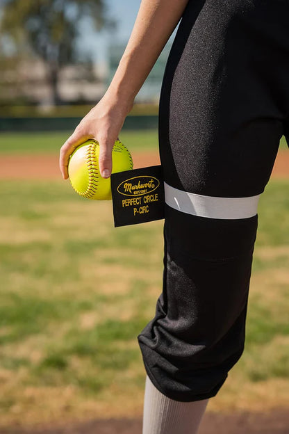person holding a softball and wearing yellow Markwort The Perfect Circle Pitcher's Training Aid on field
