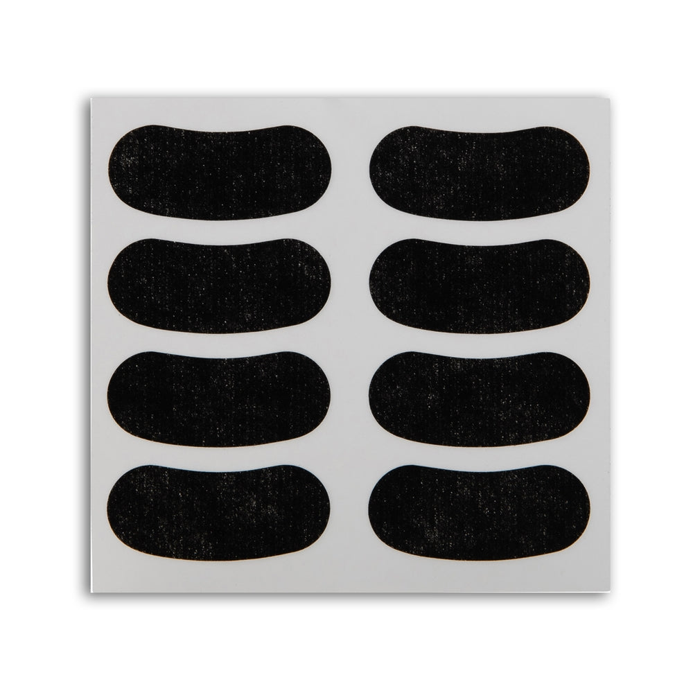Sheet of black adhesive Eye Black Stickers patches on a white background