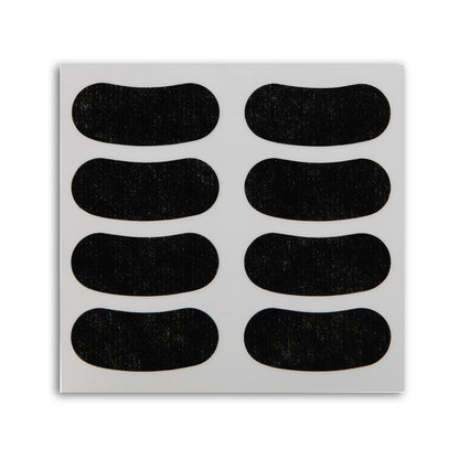 Sheet of black adhesive Eye Black Stickers patches on a white background