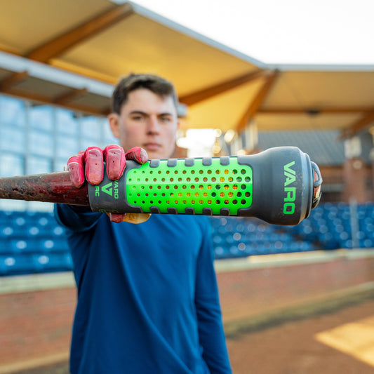 person holding a green and graphite colored Varo ARC Bat Weight 12 Oz